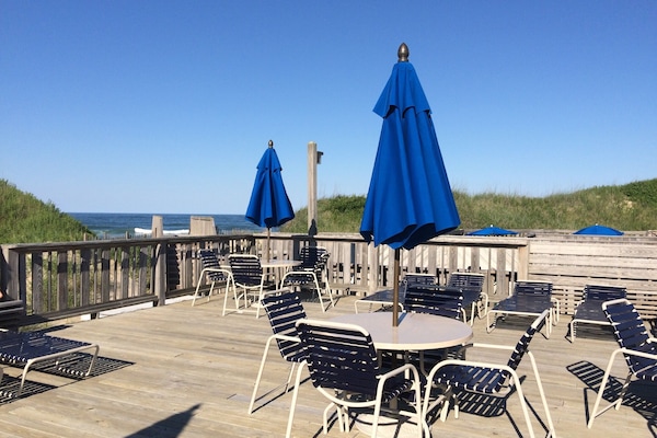 Deck view of the beach from the pool at Village Beach Club