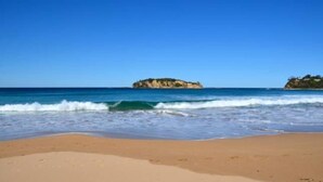 A beach with clear blue water and a sandy shore. - Beautiful Beachfront Palm Beach Style House (Rosedale)