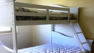 Sleep comfortably in this cozy space with a bunk bed featuring a ladder to the upper bunk.