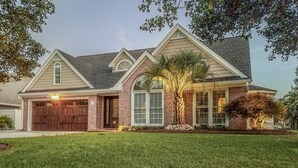 A two-story house with a garage, a front porch, and a well-maintained lawn. - Lakefront Oasis Centrally Located. Elegant, spacious and you're going to love it (Virginia Beach)
