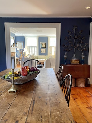 A dining area with a wooden table, chairs, and a decorative centerpiece.