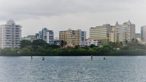 A waterfront cityscape with buildings and a calm body of water. - Condado Lagoon View - Apartment at Miramar: Beach, Night Life, family and more!! (San Juan)