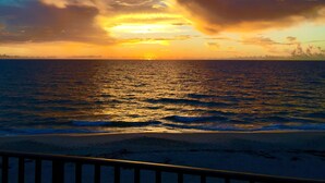 A sunset over the ocean with a beach in the foreground. - Oceanfront Condo With Incredible Views (Vero Beach)
