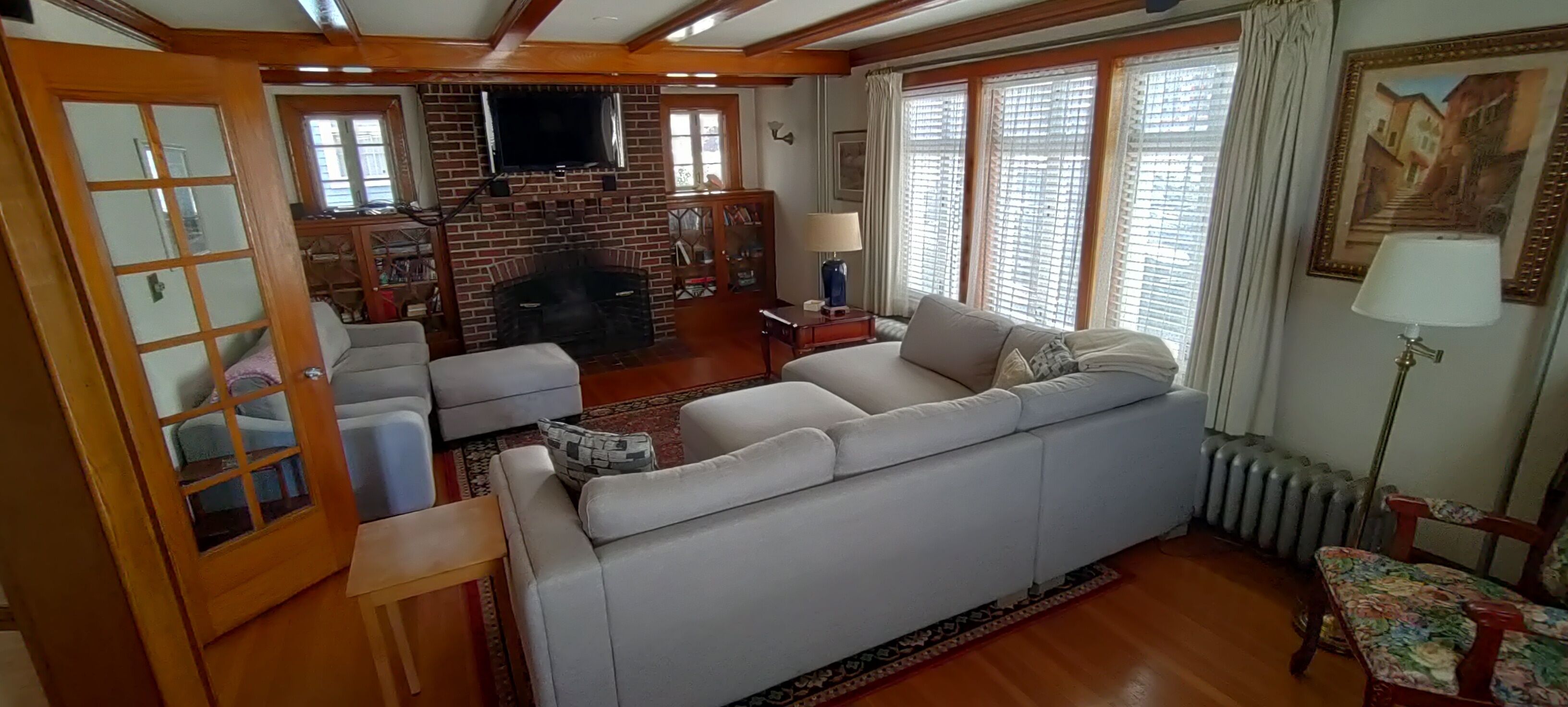 A living room with a fireplace, sofa, and a television.