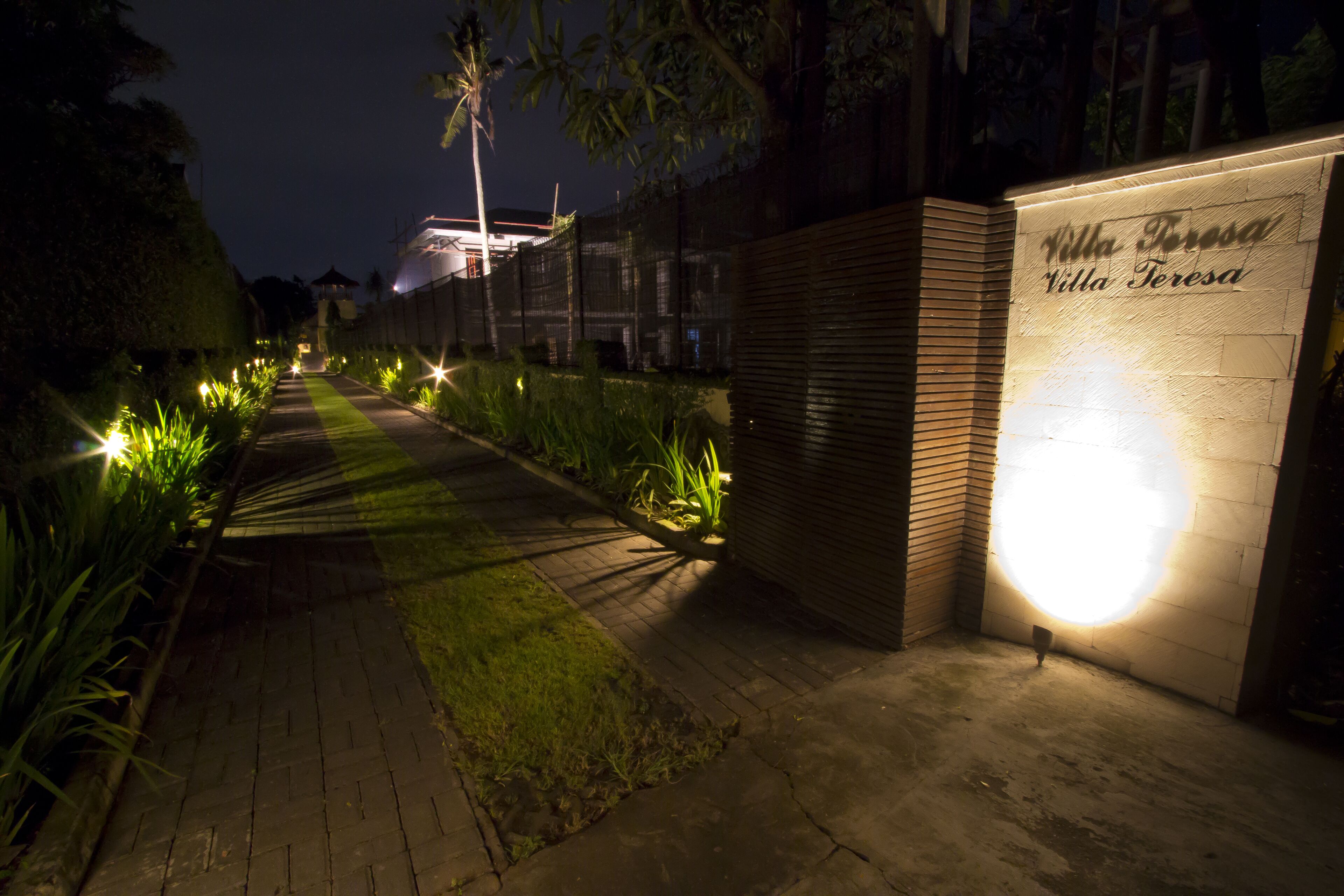 A pathway leading to a building with a sign reading "Villa Teresa."