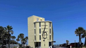 A building with a large musical note symbol on its facade. - OF Condo Gone2TheBeach @ Symphony Beach Club (Ormond Beach)