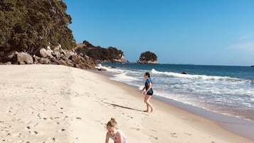 On the beach, sun-loungers