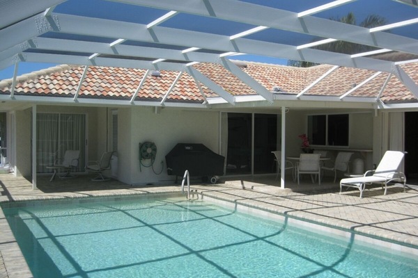 Enjoy the large south facing pool and 1700 Sq. Ft. Screened Lanai