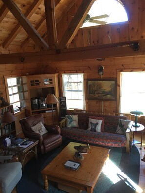 a view of the living area from the steps going to the loft.