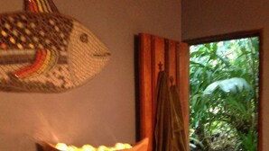 A wooden cabinet with a woven fish decoration, a bowl of fruit, and a green towel hanging on a hook. - Book now!!  Free EGGS!! Also pool, 300m to beach and great gardens! (Playa Chiquita)