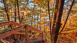 A wooden bridge in a forest with autumn leaves. - Cozy lakefront Retreat with Spa Pet Friendly (St-Armand)