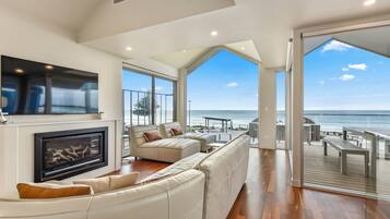 Premium House | Living area | 65-inch Smart TV with digital channels, fireplace