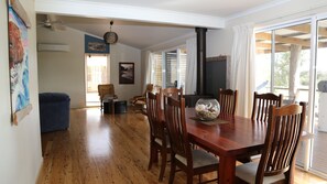 The living area flows out to and undercover deck,  complete with kitchenette.