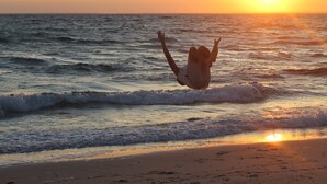 A beach scene with waves and a sunset. - Beach Front on Beautiful Jenkins Pond, Quiet Area, 
Discounted off season rates! (East Falmouth)