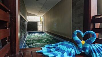 Relax by the serene indoor pool, complete with a comfortable bench and amenities at your fingertips.