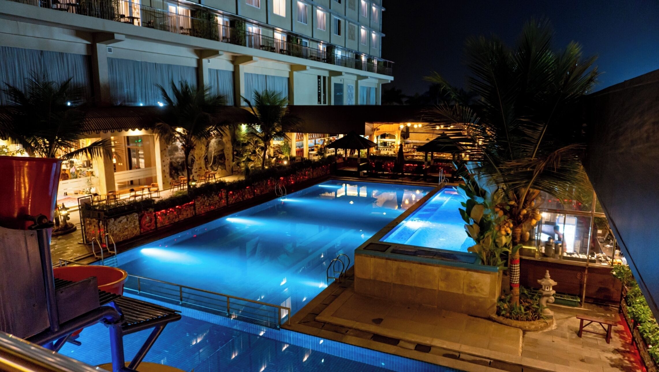 A swimming pool with a view of a hotel building in the background.