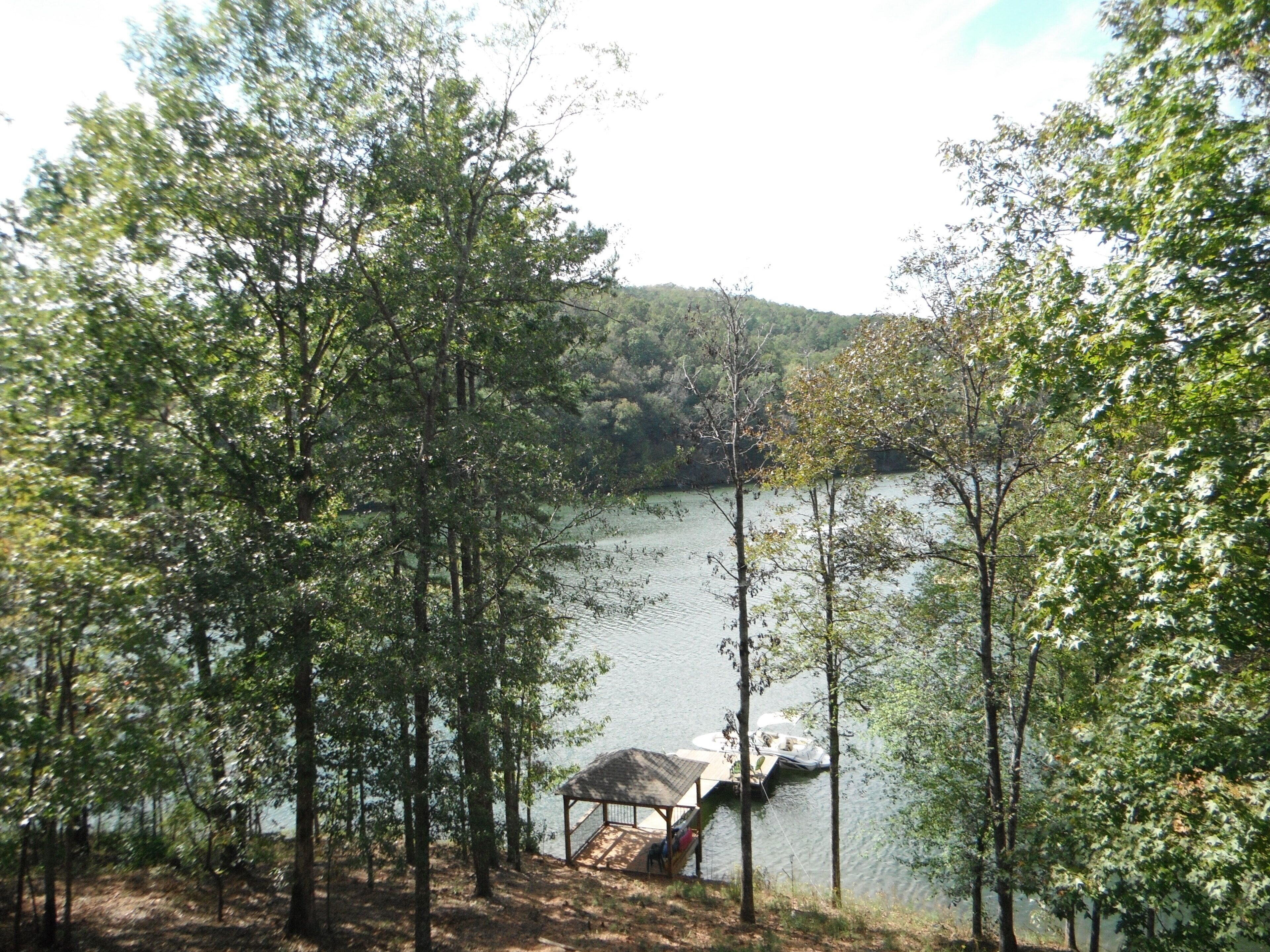 A lakeside view with a dock and a gazebo.