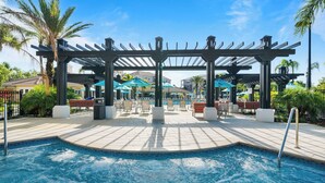 A pool area with a pergola, lounge chairs, and umbrellas. - Minutes to  Disney, Universal, SeaWorld in a resort setting 1823 sqft 3bdrm HT (Orlando)