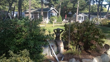 Enjoy a peaceful retreat in a serene garden setting with a stone pathway leading to the entrance.