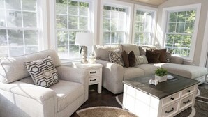 A living room with a beige sofa, a coffee table, and a side table. - Private & Super Spacious, close to downtown N. Conway and ski. (Conway)