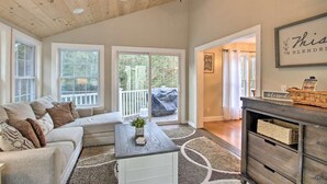 A spacious living room with a large window, a ceiling fan, and a wooden ceiling. - Private & Super Spacious, close to downtown N. Conway and ski. (Conway)