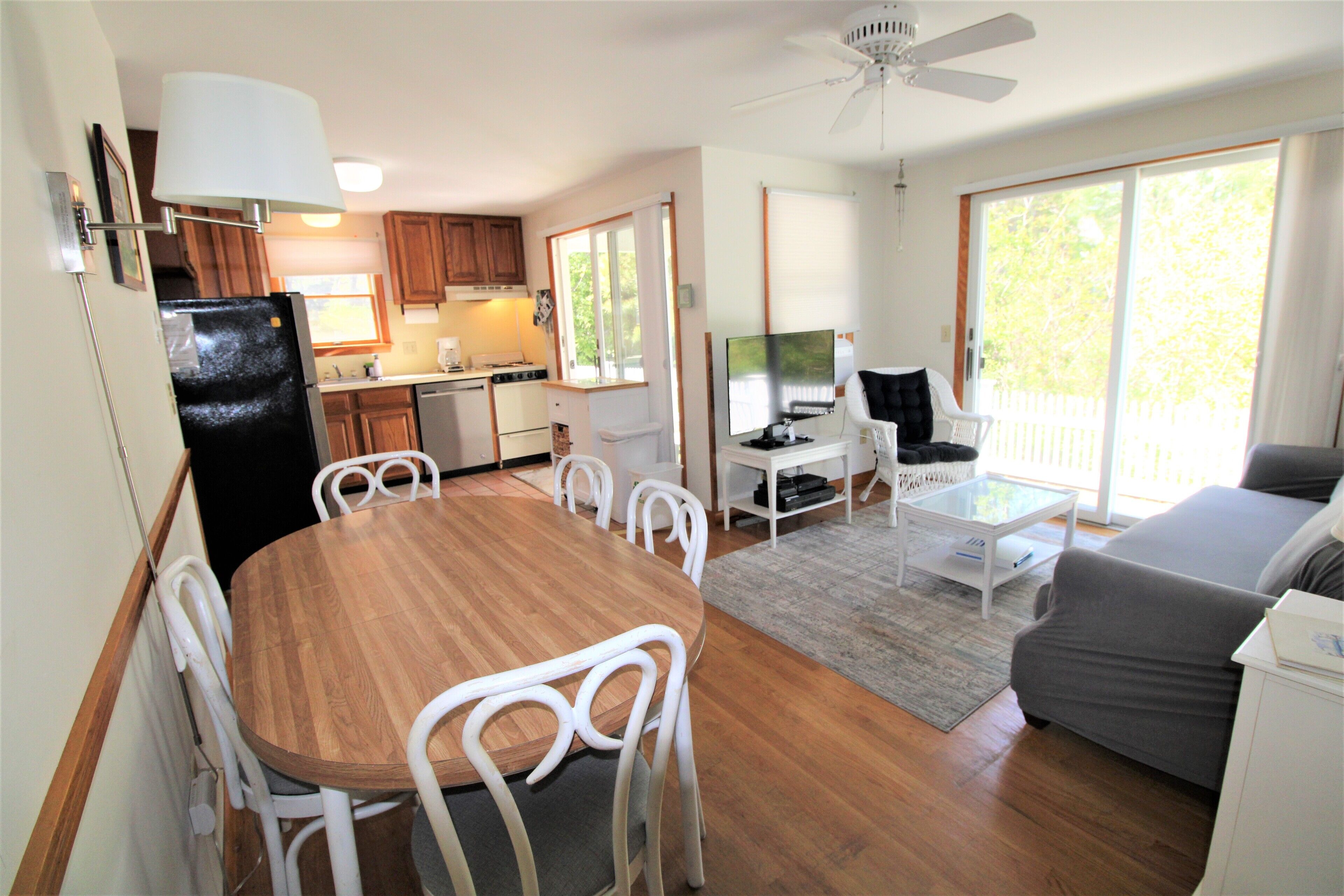 A compact living space with a dining area, kitchen, and seating area.