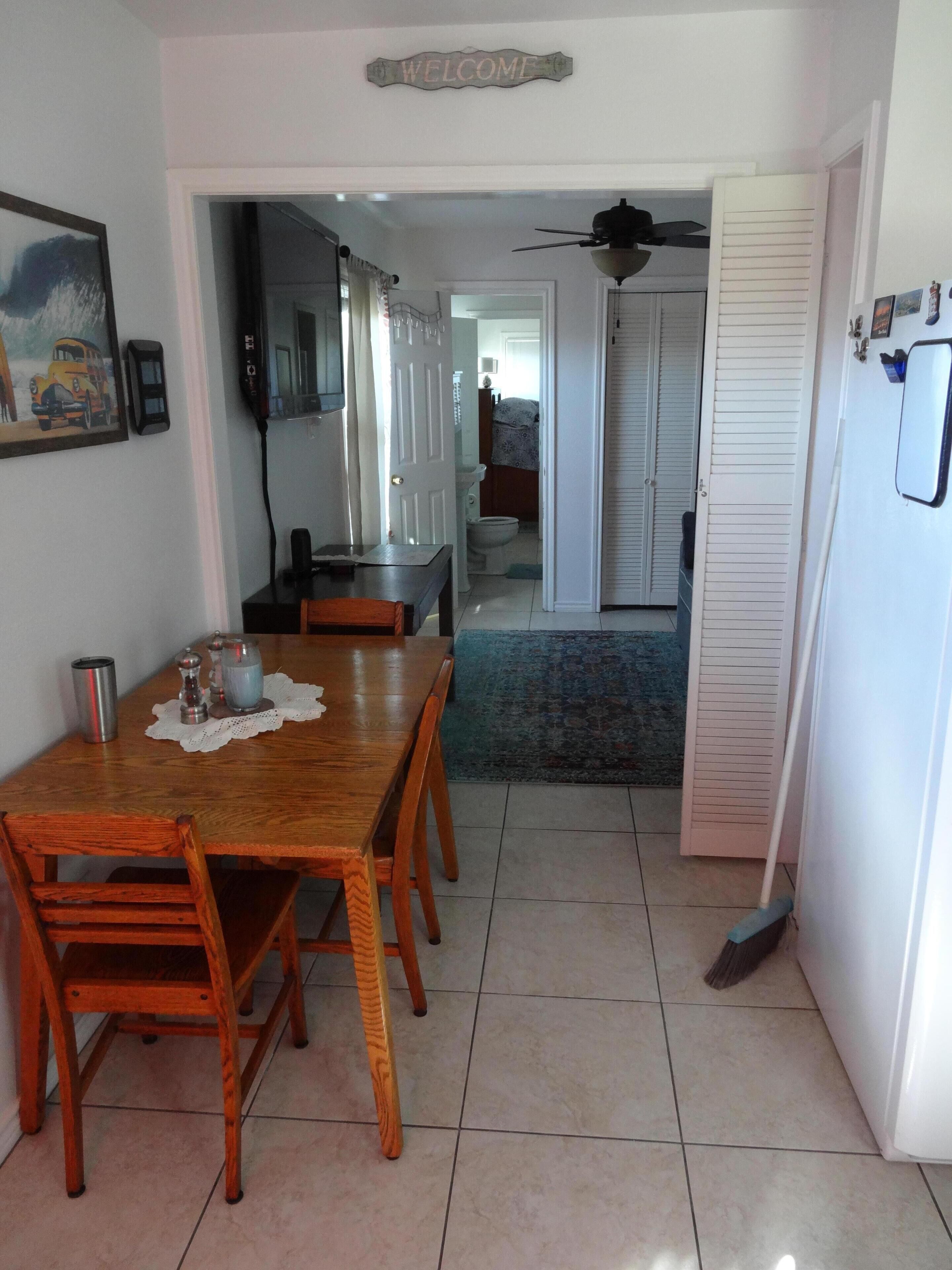 Dinning room table and three chairs off kitchen. View from entry door.