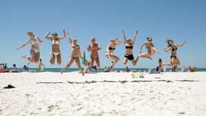 A beach with people jumping in the air. - Oceanfront 1BR/2BR Condo on 2nd Floor, 1,000 SQ FT (Panama City Beach)
