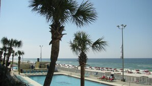 A pool area with lounge chairs and a view of the beach. - Oceanfront 1BR/2BR Condo on 2nd Floor, 1,000 SQ FT (Panama City Beach)