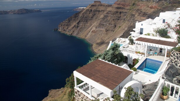 A coastal building with a swimming pool, white walls, and a view of the sea and cliffs. - Breathtaking view, luxury, privacy, style and much more ! (Firostefani)
