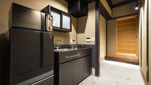 A modern kitchen with a refrigerator, stove, and sink. - Rinn Premium Yae  (Kyoto)