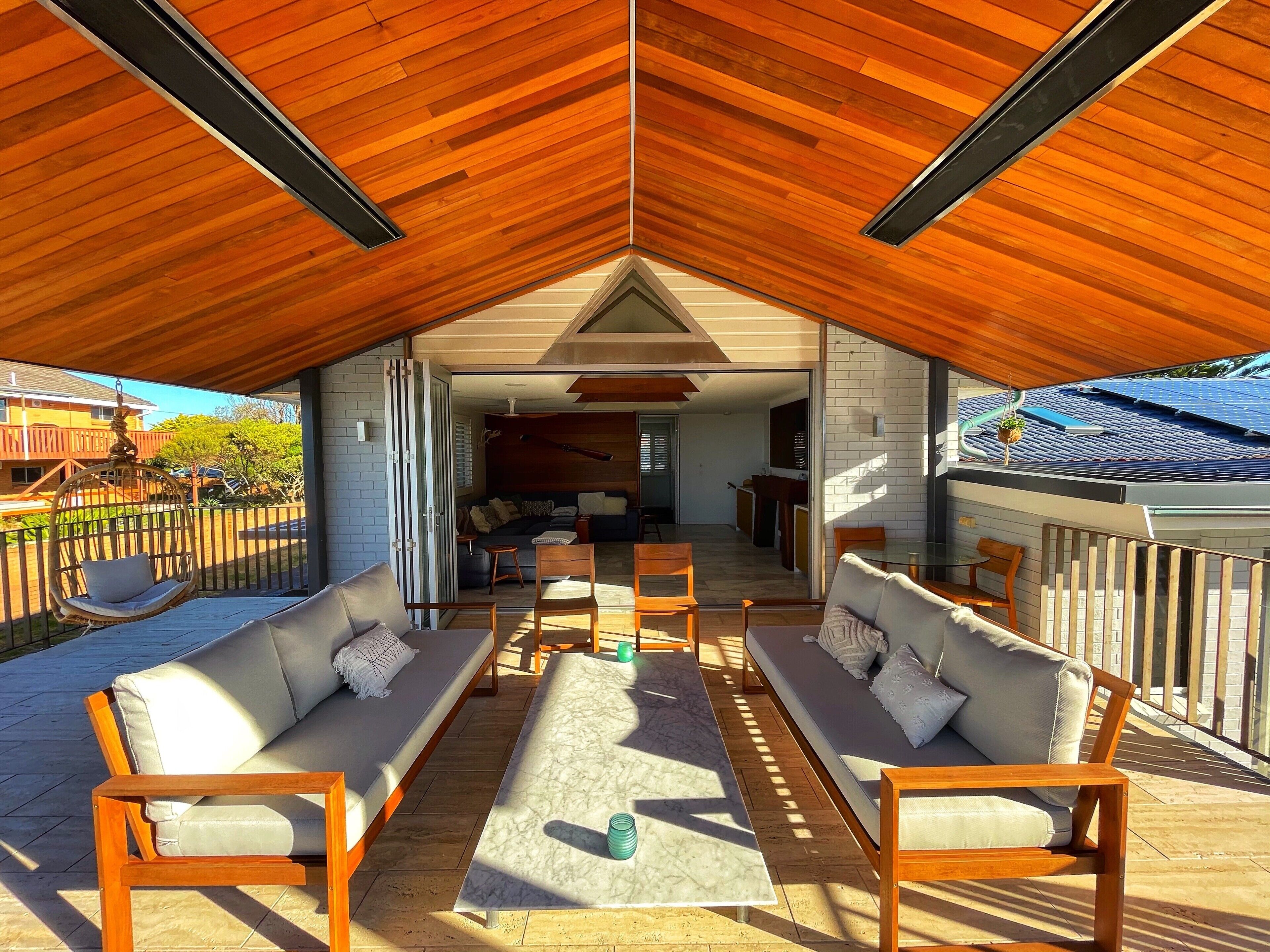 Outdoor Lounge next to Living area with ceiling electric heaters