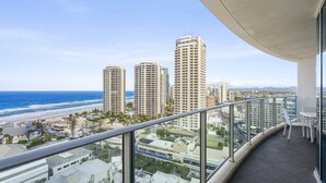 A balcony with a view of the beach and high-rise buildings. - Apartment 11504 is a holiday makers dream. Boasting a prime location (Surfers Paradise)