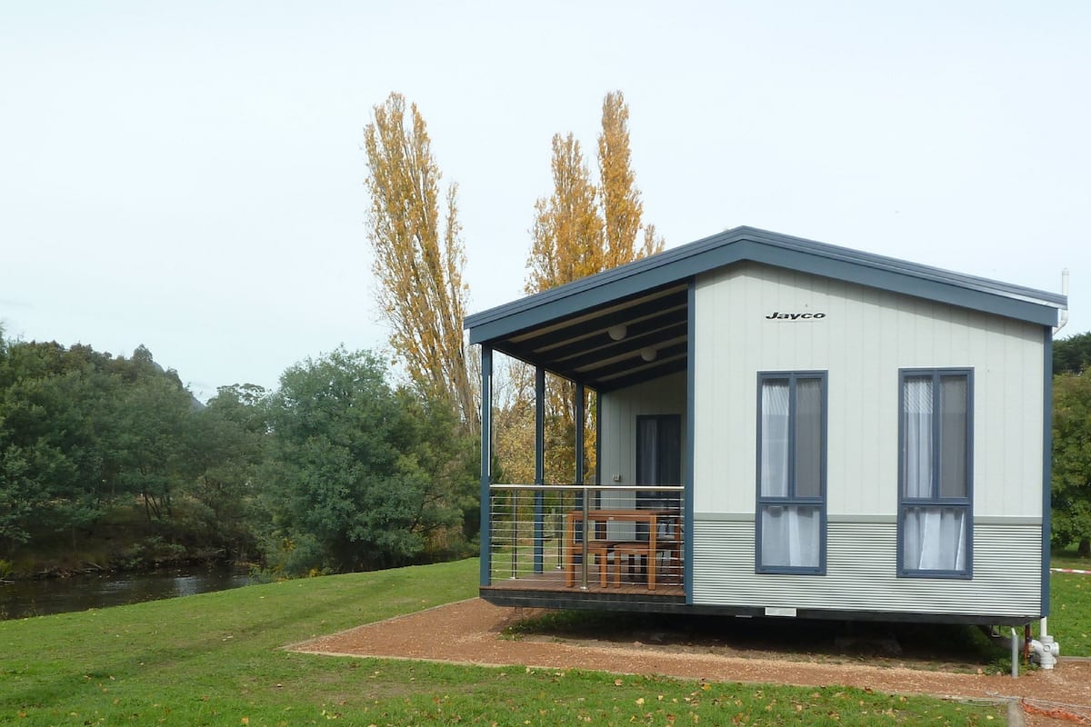 Three-Bedroom Riverfront Cabin | Living area | TV