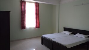 A bedroom with a bed, a ceiling fan, and a window with curtains. - Spacious Beautifuly Furnished 3 Bedroom, Hall & Kitchen apartment. (Hyderabad)