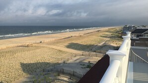A beach view with a sandy area and a wooden fence. - LBI Oceanfront. Beautiful! Views galore. Dine overlooking the dunes. (Beach Haven Crest)