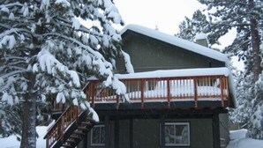 A two-story lodge with a wooden deck and a staircase leading to the upper level. - Comfortable, Spacious, Pet-Friendly Home
Located close to all the best of Tahoe (South Lake Tahoe)