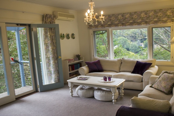Living room with garden and mountain views