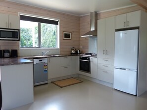 The kitchen is spacious and equipped with modern appliances.