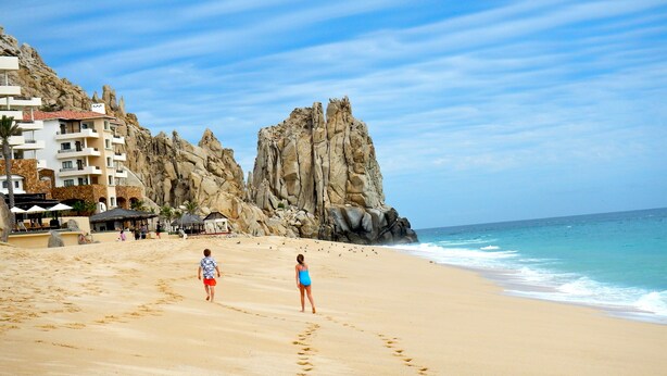 A beach with footprints leading to a rocky cliff. - Terrasol 2BR/2BA Beach Condo - Best Price, Best Location & Ocean beachfront (Cabo San Lucas)