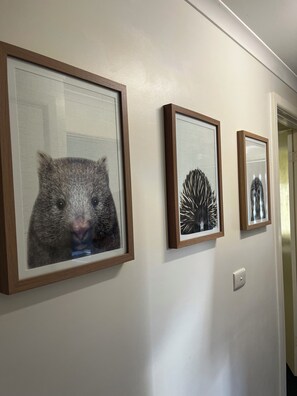 A hallway with three framed pictures on the wall. - Ventnor Anchorage Site (Ventnor)