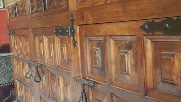 A wooden cabinet with intricate carvings and multiple drawers.