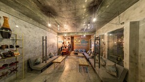 A cozy, well-lit interior with a reception desk, seating area, and display shelves. - Club Gabbiano Rasdhoo (Rasdhoo)