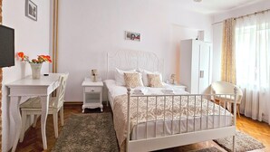 A bedroom with a bed, bedside table, chair, wardrobe, and a desk with a chair. - Amazing house with beautiful garden, 5 bedrooms, terrace, in the City Centre (Sibiu)