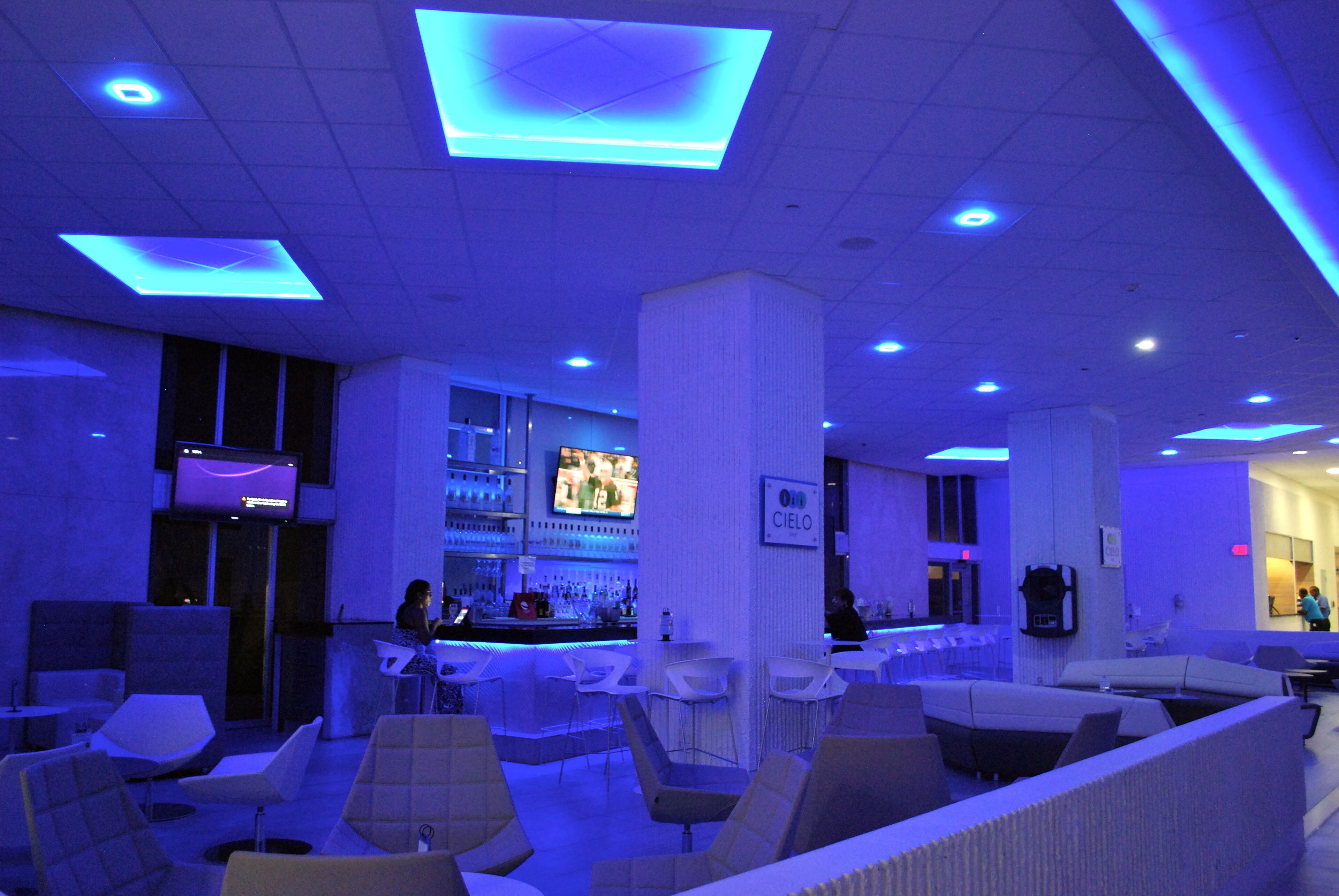 A modern lounge area with seating and a bar.