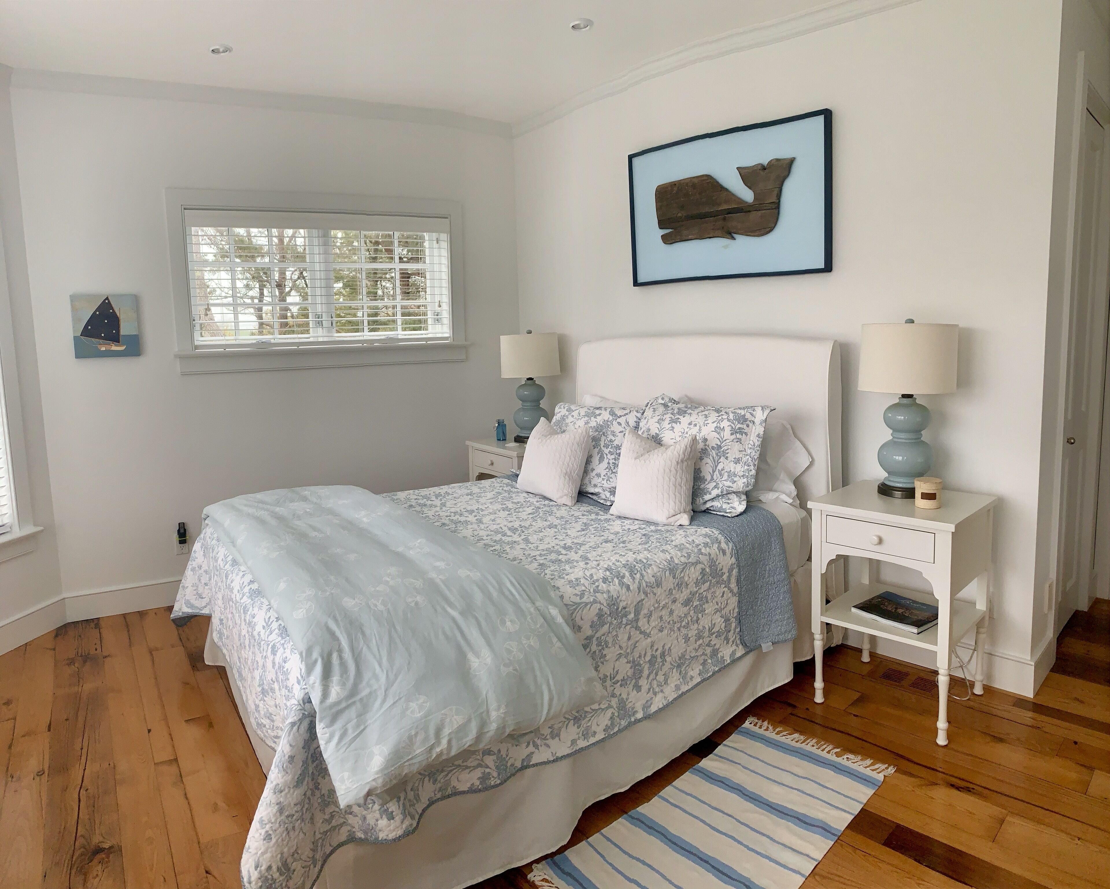 Spacious bedroom with queen bed and views to the front yard.