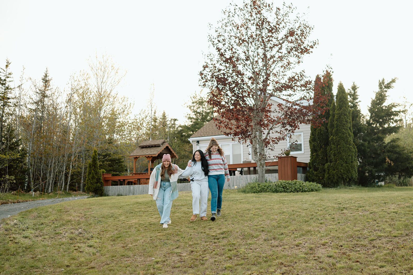A residential area with a house, a wooden deck, and a grassy yard.