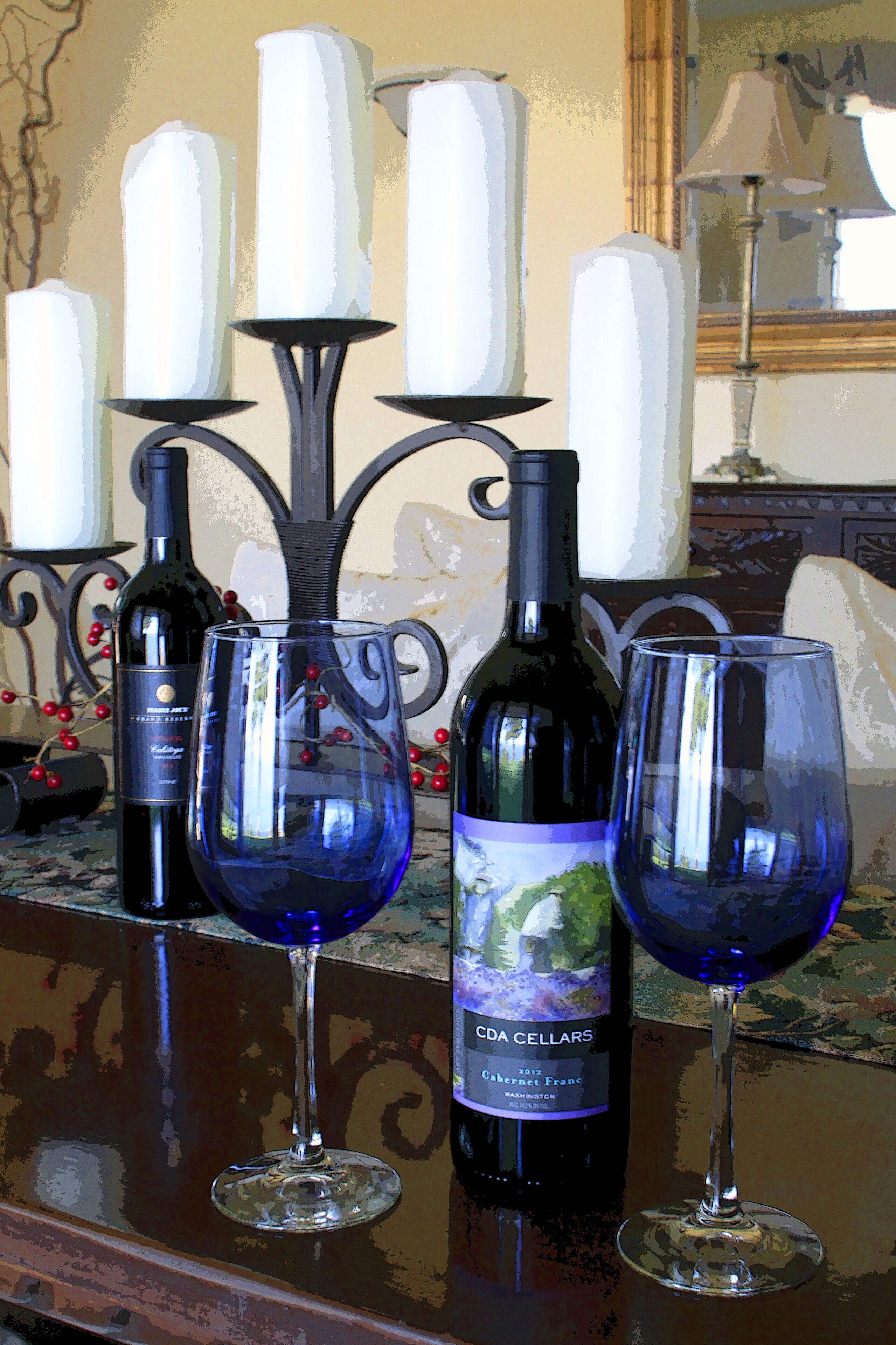 A table with two wine glasses and a wine bottle.