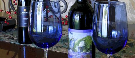 A table with two wine glasses and a wine bottle.