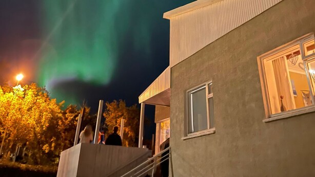 A building with a modern architectural style, featuring a flat roof and a large window. - Apartment close to center of town in a quiet area (Akureyri)